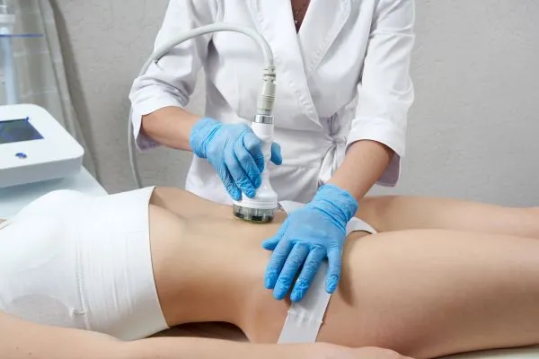Lost the Weight but Not the Loose Skin? 2 woman having HIFU treatment on her stomach to combat loose skin Barton-le-Clay following weight loss